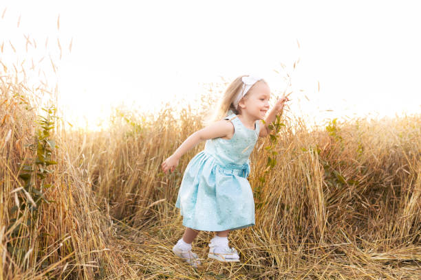 istock Little girl smiling on meadow at sunset 855778266