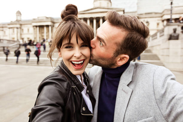 Happy couple taking selfie in front of National Gallery in London Beautiful happy couple taking selfie with National Gallery in the background. Close up of faces. Autumn season. stylish selfie stock pictures, royalty-free photos & images