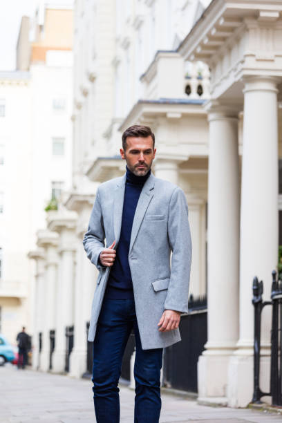 Outdoor portrait of elegant handsome man standing in the city street Outdoor portrait of elegant handsome man standing in the city street in London. Autumn season. victoria house stock pictures, royalty-free photos & images