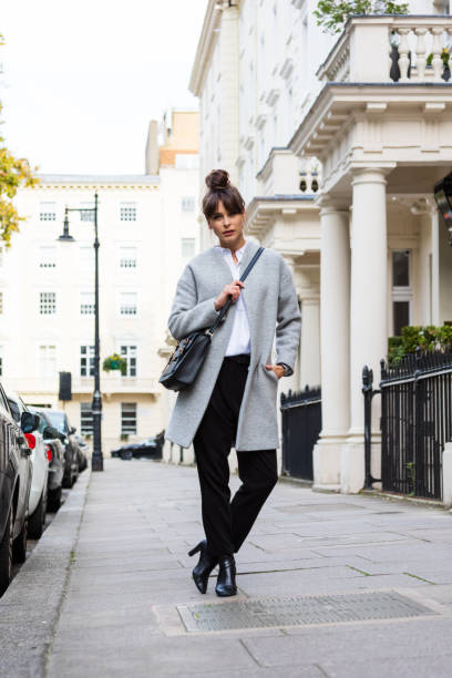 Outdoor portrait of elegant beautiful woman standing in the city street Outdoor portrait of elegant beautiful woman standing in the city street in London. Autumn season. victoria house stock pictures, royalty-free photos & images