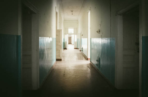 istock Abandoned long corridor and room in old house 855783728