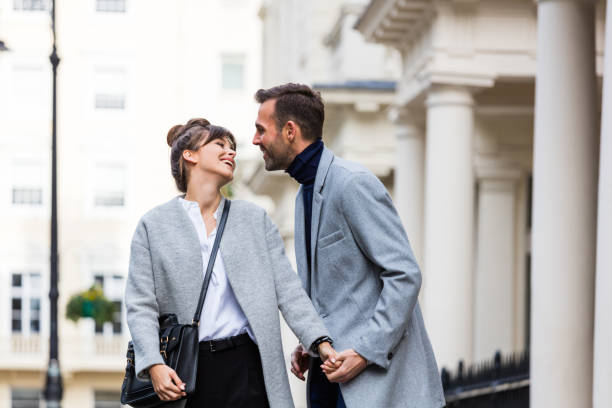 Happy romantic couple flirting in the city street Happy romantic elegant couple flirting in the city street in London. Autumn season. victoria house stock pictures, royalty-free photos & images