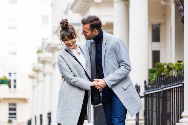 Happy romantic couple flirting in the city street Happy romantic elegant couple flirting in the city street in London. Autumn season. victoria house stock pictures, royalty-free photos & images