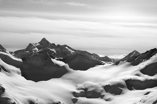 Black and white snowy mountains in evening. Caucasus Mountains in winter. View from mount Elbrus.