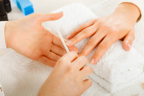 istock Woman getting manicure done file nails 855788622