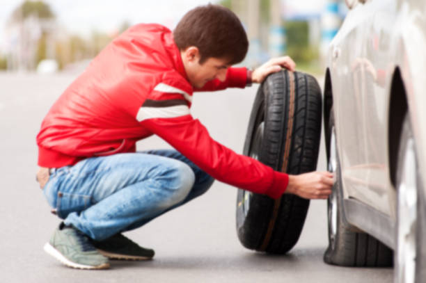 istock Male driver changing wheel after car breakdown 855788742