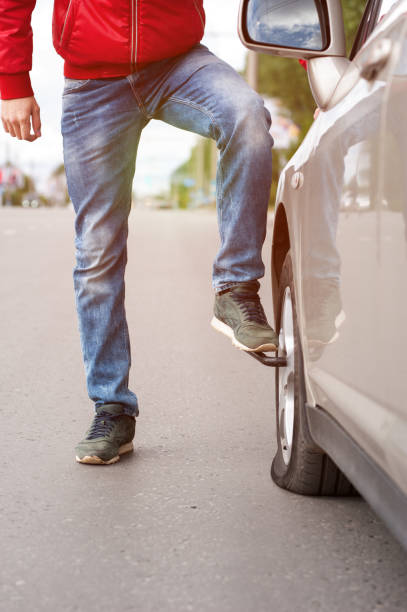 istock Male driver changing spare wheel on cityroad 855789206
