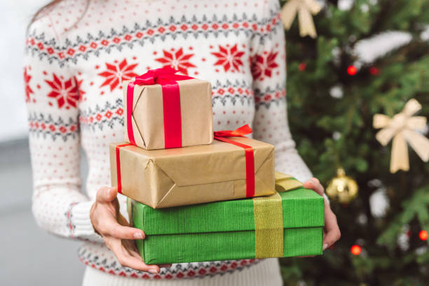istock girl holding christmas presents 855789476
