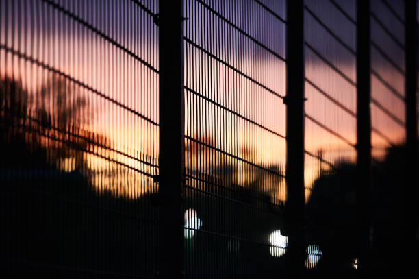 metal fence and sky at sunset closeup