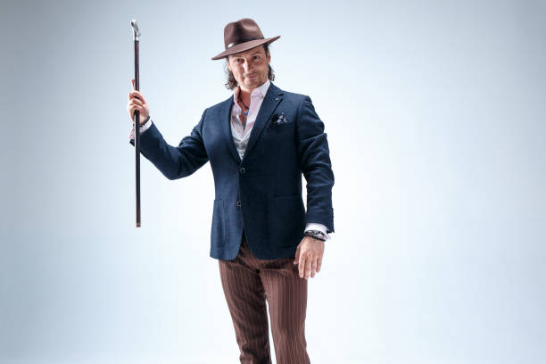 istock The mature man in a suit and hat holding cane 855791938