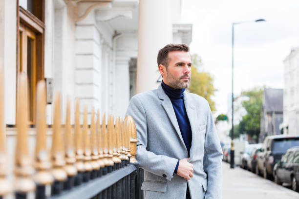 Outdoor portrait of elegant handsome man standing in the city street Outdoor portrait of elegant handsome man standing in the city street in London. Autumn season. victoria house stock pictures, royalty-free photos & images