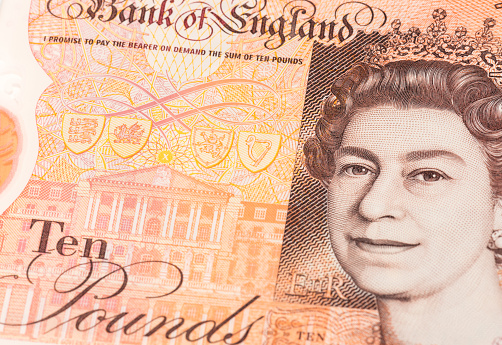 Edinburgh, UK - Closeup showing a portrait of Queen Elizabeth II on a newly issued polymer British ten pound note.