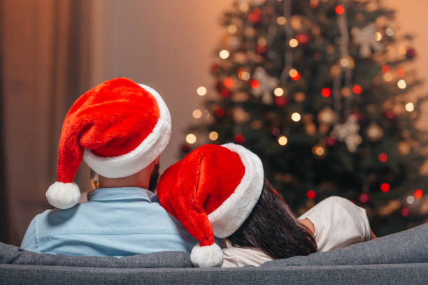 istock couple in santa hats 855795788