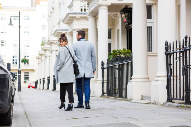 Back view of elegant couple walking in the sidewalk Back view of smart casual romantic couple walking in the city street. Autumn season. victoria house stock pictures, royalty-free photos & images