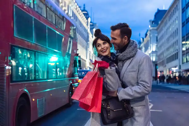 Photo of Romantic couple after shopping in London at dusk, autumn season