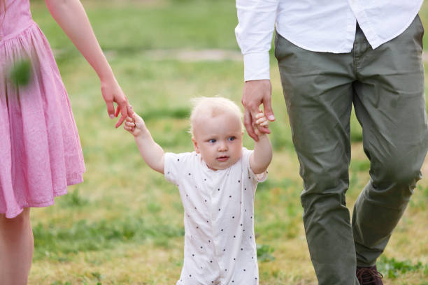 istock Baby's first independent steps at greeen grass outdoors 855800246
