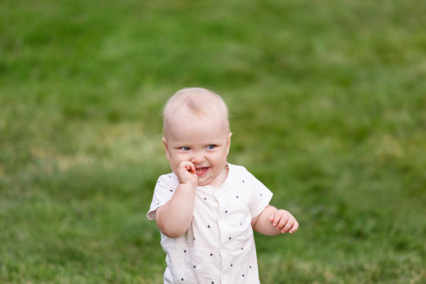 istock Baby's first independent steps at greeen grass outdoors 855801042