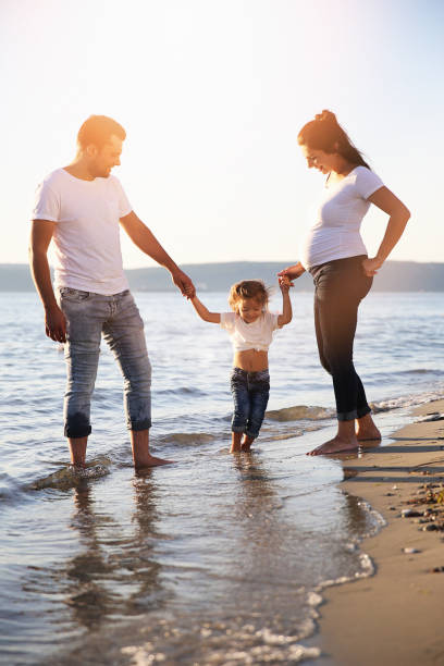 istock Young  family holding their daughters and laughing together 855807358