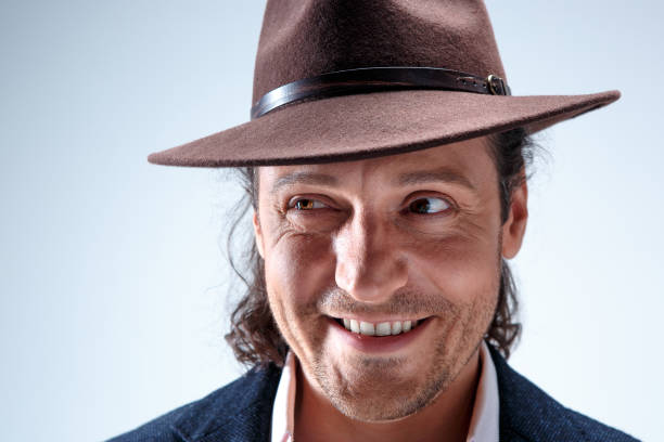 istock Young man portrait with hat on gray studio background 855807648