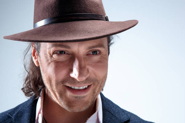 istock Young man portrait with hat on gray studio background 855808178