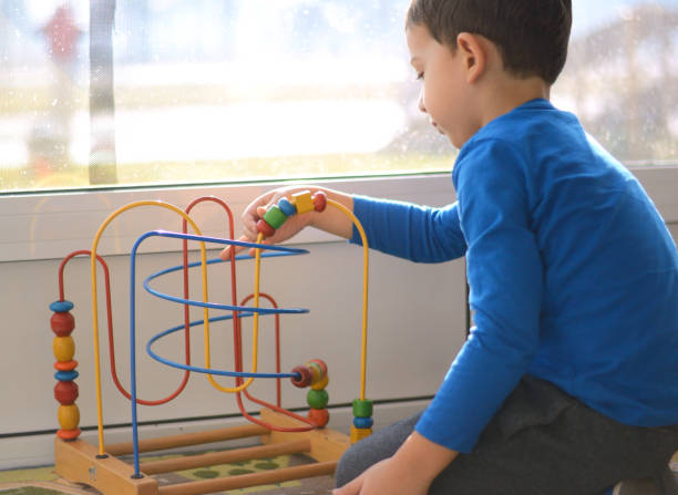 istock Cute little boy is playing with educational toys 855809090