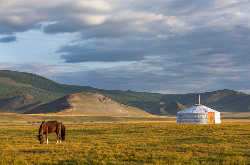 View of Mongolian gers against cloudy sky, Bayanzag, Mongolia.