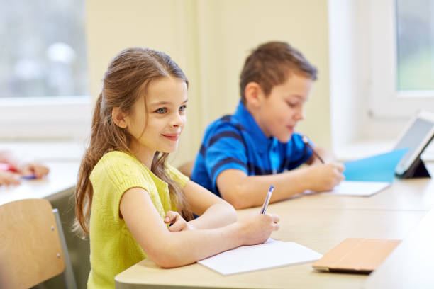 istock group of school kids writing test in classroom 855811738
