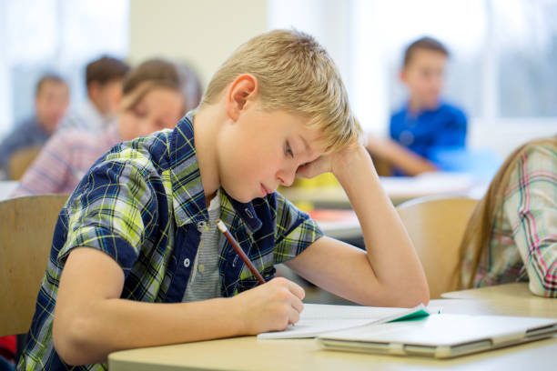 istock group of school kids writing test in classroom 855811864