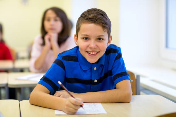 istock group of school kids writing test in classroom 855812098