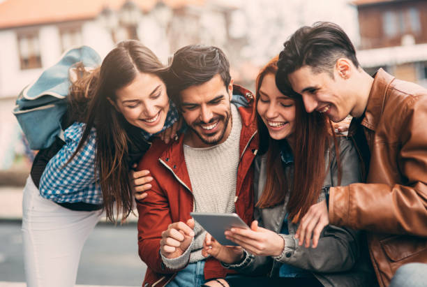 istock Friends using a tablet in the city 855812104