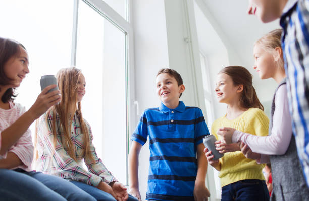 istock group of school kids with soda cans in corridor 855812524