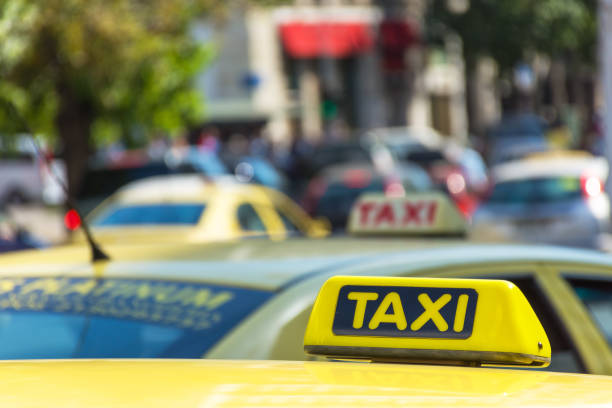 istock Yellow taxi sign on cab vehicle roof 855814946