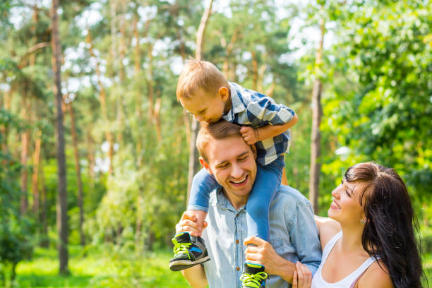 istock Daddy carries his son on his shoulders, mom laughs next to them 855817116