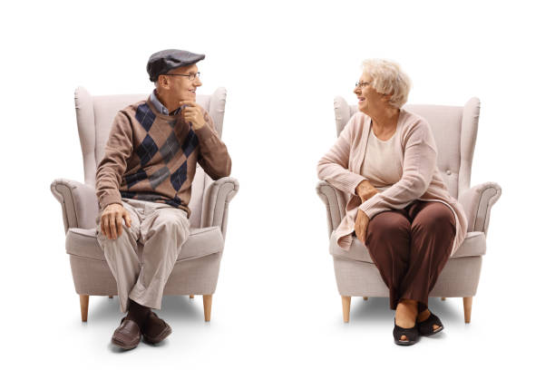 istock Seniors sitting in armchairs and having a conversation 855817206