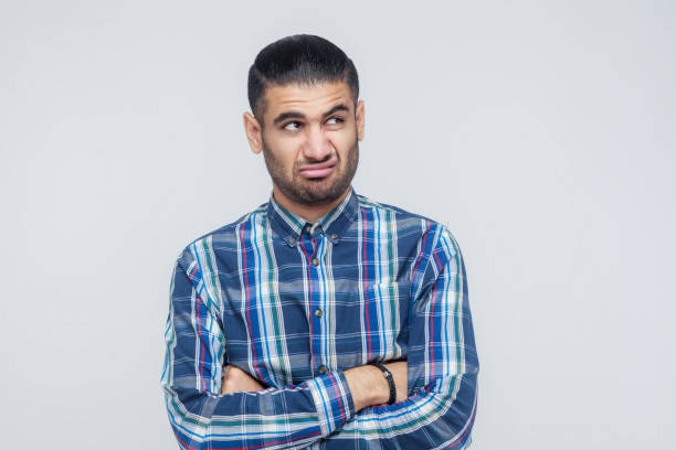 istock Indoor isolated studio shot on gray background of man looking away. 855820320