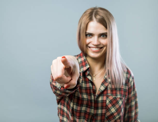 istock Young pretty woman stretching her hand with index finger 855825616