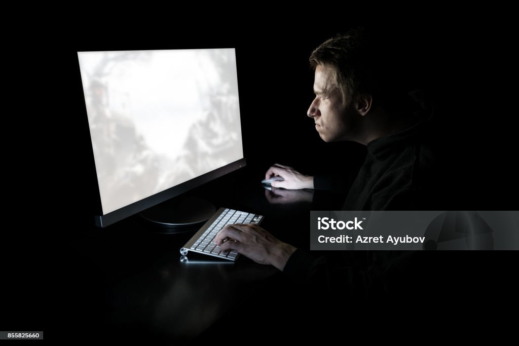 Young gamer play online with friends. Dark scene with gaming PC and lots of  RGB light Stock Photo - Alamy