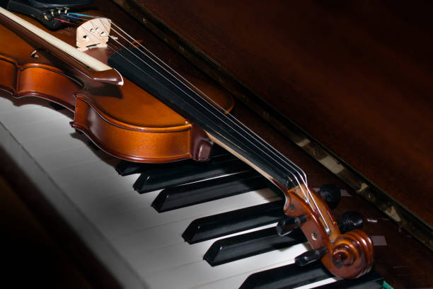 istock Very old violin lying on the piano 855832790