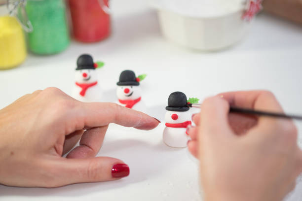 istock Making snowman for Christmas cupcakes, figurine 855833290
