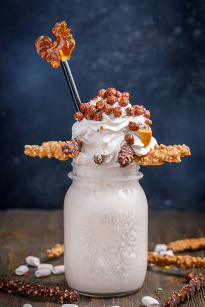 istock Unusual milkshake decorated with candies, marshmallows, whipped cream and other sweets. Milkshake for children. 855833404