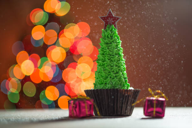 istock Cupcake with Christmas Tree on top of it, snow 855835786