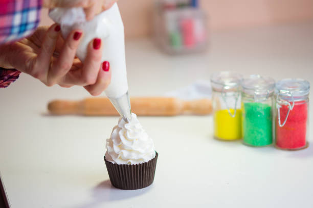 istock Making Christmas cupcakes, icing and preparing food 855836334