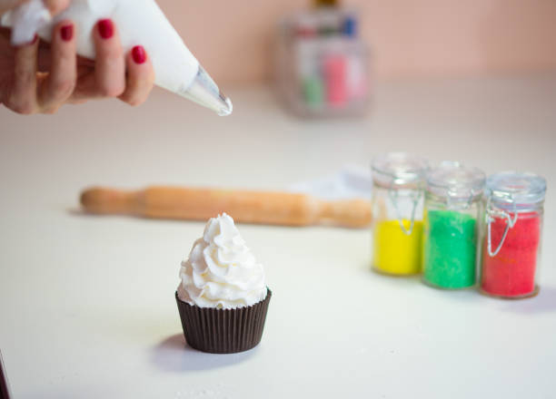 istock Making Christmas cupcakes, icing and preparing food 855836608