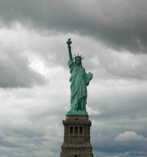 istock Statue of liberty with grey and cloudy sky. 855847330
