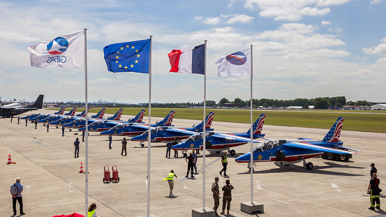 PARIS, FRANCE - JUN 23, 2017: France and EU flags in front of the Patrouille de France aerobatic team at the Paris Air Show 2017