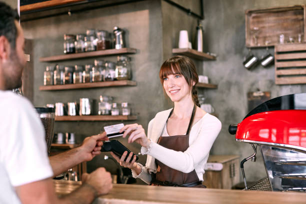 istock Staff Serving Customer In Busy Coffee Shop 855848160