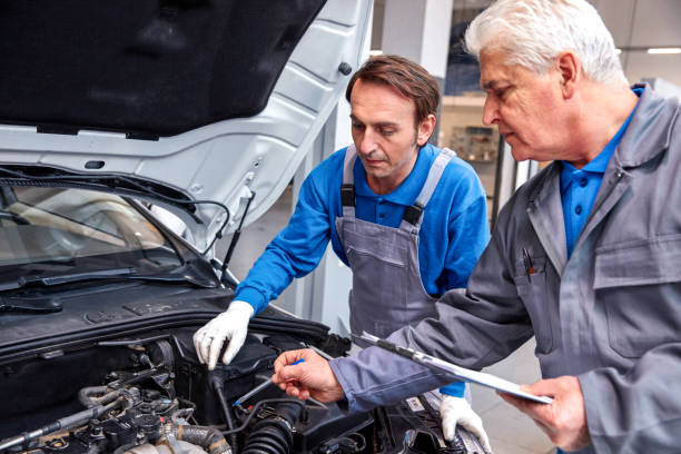 istock Mechanic And Male Trainee Working Together 855849036