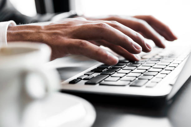 istock Fast typing on a laptop with cup of coffee 855853252