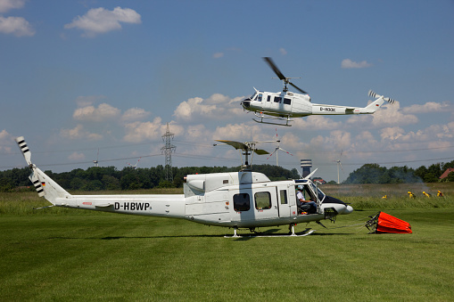 AHLEN, GERMANY - JUN 5, 2016: Bell 205 and Bell 212 Huey helicopters during a fire fighting demonstration at Ahlen-Nord heliport