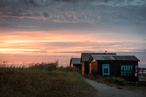 Harbour huts at sunset Alongside the River Blyth at Walberswick, Suffolk, UK southwold stock pictures, royalty-free photos & images